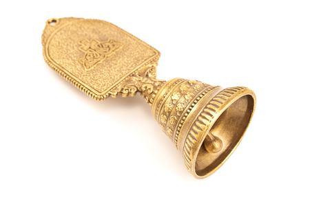 Golden antique hand bell isolated on whiteの写真素材