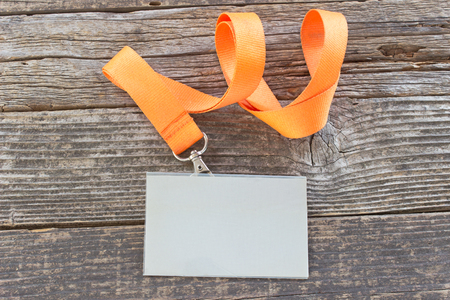 Blank  ID card tag with ribbon on wooden backgroundの写真素材