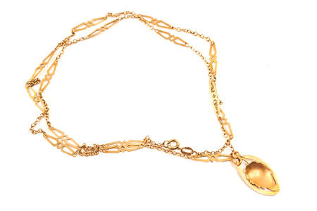 Golden necklace with leaf pendant isolated on whiteの写真素材
