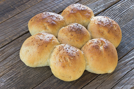 Bread in shape of flower on wooden background
