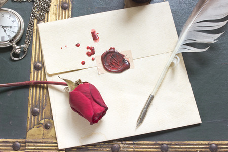 Wax sealed love letter with rose and quill on vintage backgroundの写真素材