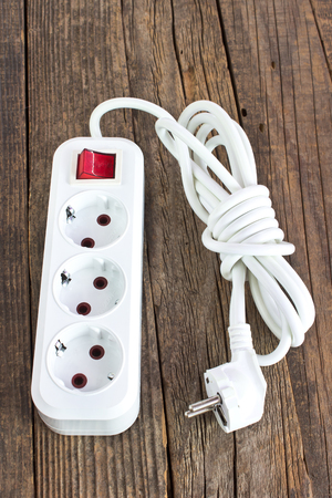 Electric plug power cable on wooden backgroundの写真素材