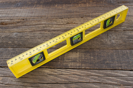 Level tool on wooden background