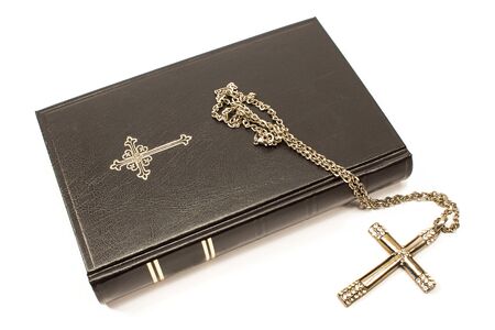 Holy bible with silver cross isolated on white backgroundの写真素材