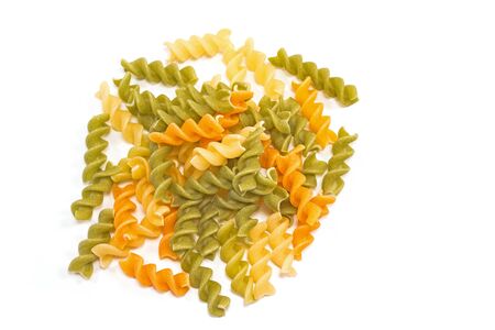 Fusilli tricolore raw dry pasta pile isolated on whiteの写真素材