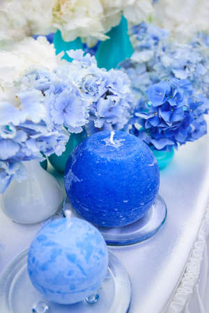 blue wedding table decoration with hydrangeas and candles