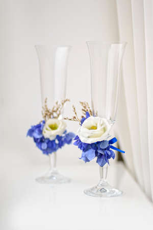 Two goblets decorated with flowers for a wedding reception in blue tonesの写真素材