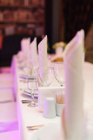 Glass goblets on the prepared table for celebretion in the luxury restaurant