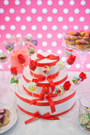Sweet buffet with colorful cake pops decorated like a flowers for a party, event or weddingの写真素材