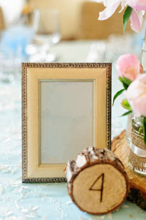 Wooden photo frame like decoration on the table for wedding in rustic styleの写真素材