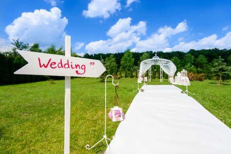 White wooden arrow sign show the way to wedding ceremonyの写真素材