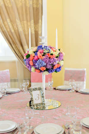 All is ready for wedding celebrations in luxury restaurant: covered tables with a lot of flowers in pink tonesの写真素材