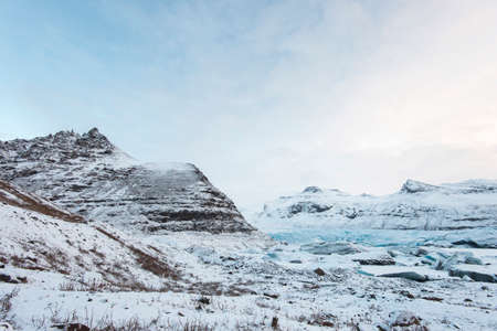 Scenic snow covered land and mountains in Iceland during winter.の写真素材