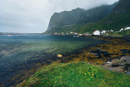 Amazing view of Lofoten islands  village Reine near clear green water and beautiful mountains in cloudy weather.   Beauty of Hamnoya, Lofoten islands, Norwayの写真素材