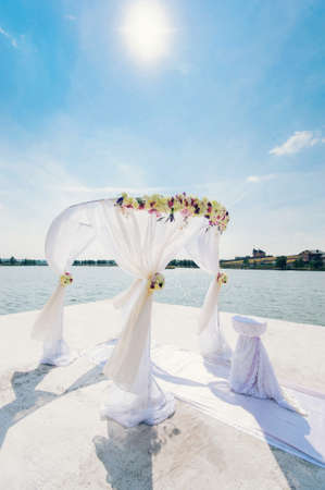 Beautiful place near the lake decorated for the wedding ceremony / the way to the happinessの写真素材