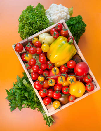 organic food background Vegetables in the basket on the kitchen tableの写真素材