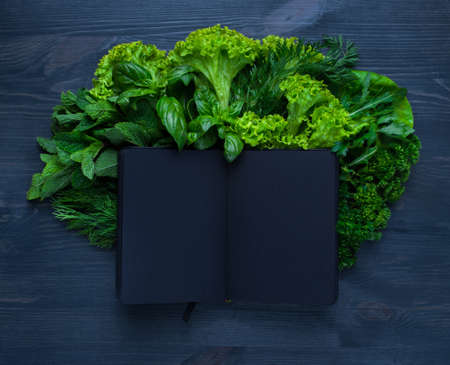 Composition with salad and bible on wooden backgroundの写真素材