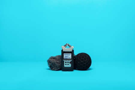 equipment for field audio recording on blue background. Microphone, recorder and windshieldの写真素材