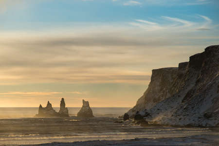 Beautiful view of the Reynisfjara coast in winter sunset. Vik, Iceland.