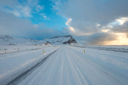 Highway around winter Iceland in the morning. Road to adventures in mountainsの写真素材