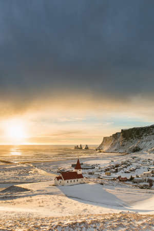 Beautiful view of the small town Vik near Reynisfjara coast and the mountains in winter Iceland in...
