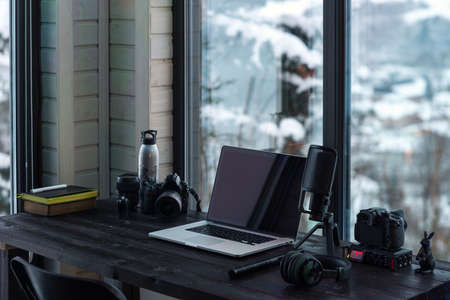 Audio / Video editing workspace office with mountain view. Photography and videography equipment.の写真素材
