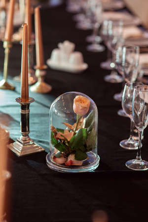 Rose in a glass flask. Wedding decor, interior. Festive. Banquet tableの写真素材
