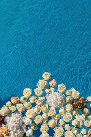 The pool filled with white rose flowers. Wedding decorの写真素材