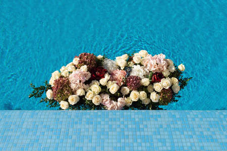 The pool filled with white rose flowers. Wedding decorの写真素材