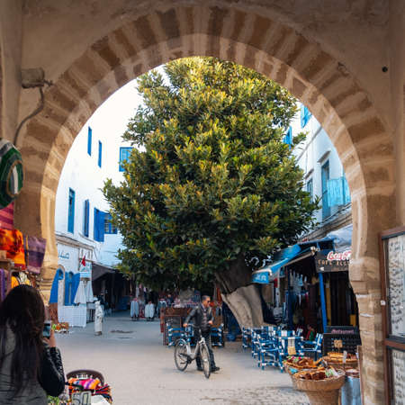 An old street with cafe in old city of Essaouira. Man with his bicycleのeditorial素材
