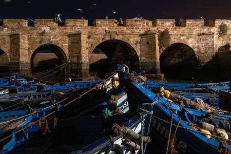 Fishing port of Essaouira at the night time, Morocco. Blue ships in the night port of Essaouiraのeditorial素材
