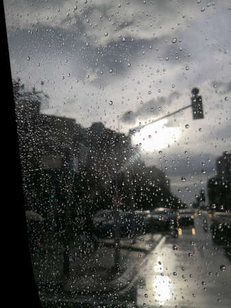 Time to dream through the view from the vet window of a car. Raindrops, sunlight, reflections on the...