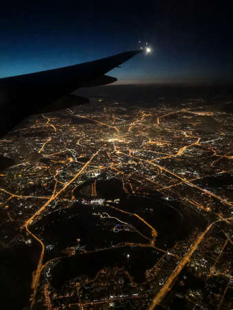 Beautiful view of shiny Moscow from an airplane window at night before sunrise. Russia, Moscow, 2019.の写真素材
