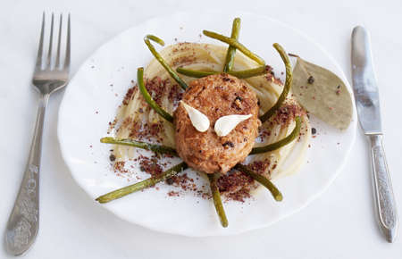 Appetizing chopped meat cutlet with a spaghetti and fried garlic in spicy spices