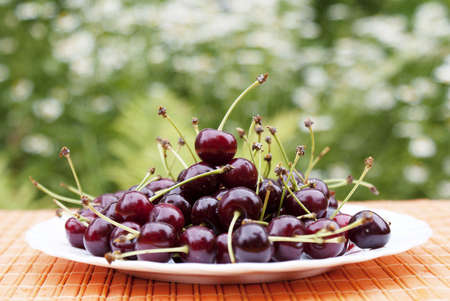  Natural fresh cherry on a table in a summer garden