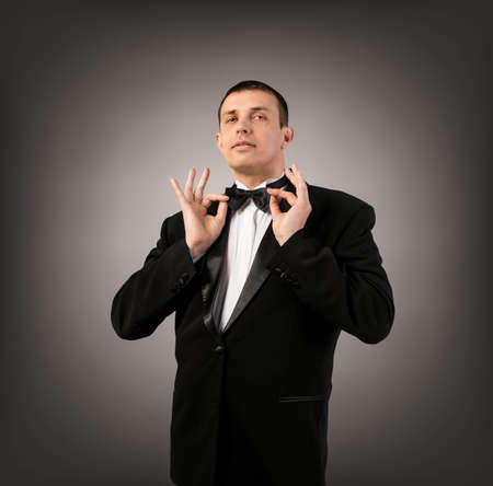 Man in Black Tuxedo on dark grey background