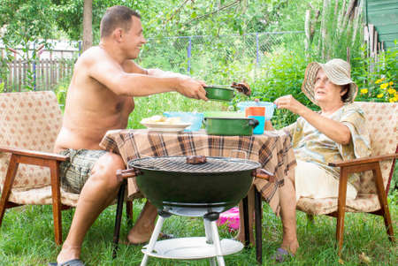 Happy family eating a barbecue in summer garden Lifestyleの写真素材