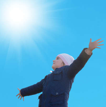 Happy little girl on blue sky  backgroundの写真素材