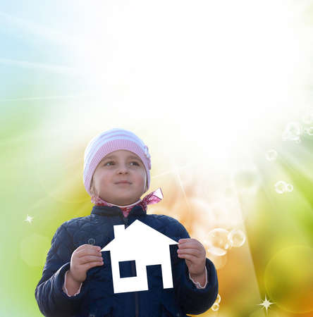 Little happy Girl with paper house on hands.Happiness Familyの写真素材