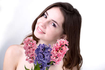 Beautiful young woman with fresh colorful bouquet flower hyacinthsの写真素材