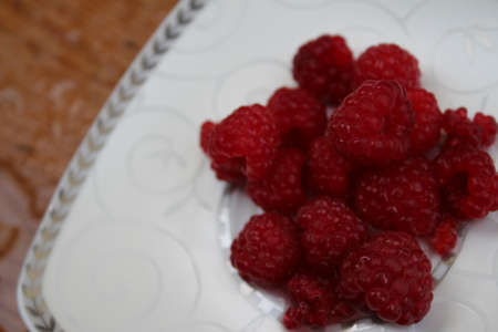 Raspberry jam is made. Raspberry jam has been made since ancient times. Red berries on a white...