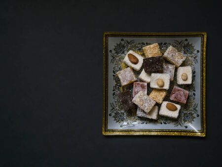 Eastern sweets. Traditional Turkish delight Rahat lukum on ceramics plate with typical folk patternsの写真素材