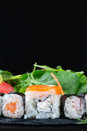 Sushi rolls with rice, herbs and soy sauce, close-up