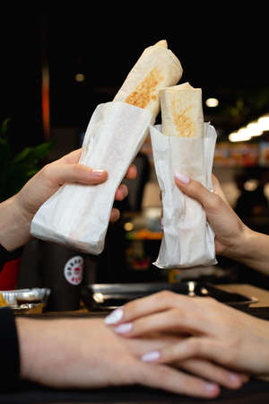 Hands holding shawarma. Fast Food Conceptの写真素材