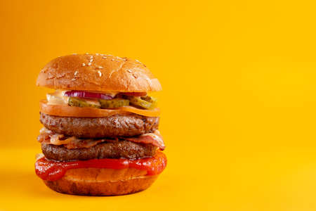 A delicious fresh burger with mushrooms and marinated cucumbers.の写真素材