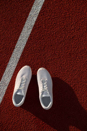 White athletic sneakers on a stadium  . Concepts of sport, health and wellness.の写真素材