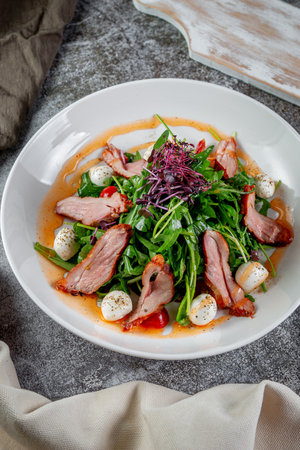 Smoked duck breast salad with vegetables and spicesの写真素材