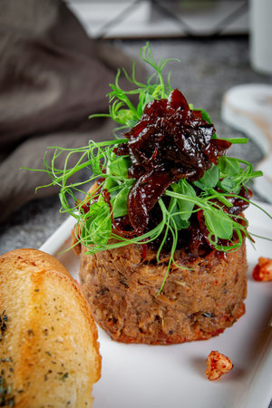Salad with liver pate, prunes and pea greens and fried croutons.の写真素材