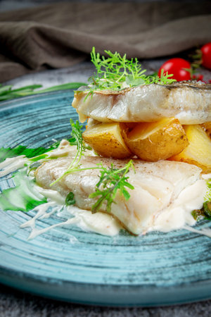 Fried perch with potatoes and cream sauceの写真素材