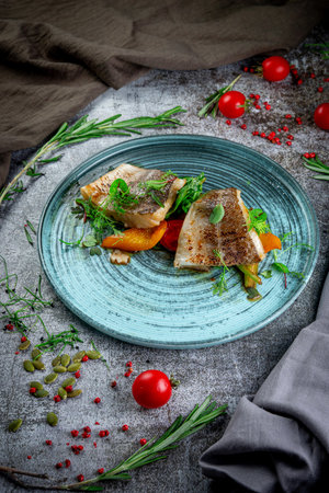 Fried pikeperch with vegetables and herbsの写真素材
